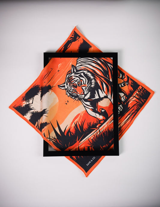 The Bengal Majesty luxury silk pocket square by Sans & Co, featuring a majestic Bengal tiger against a vibrant orange sunset with bold black jungle silhouettes and intricate wildlife-inspired detailing.