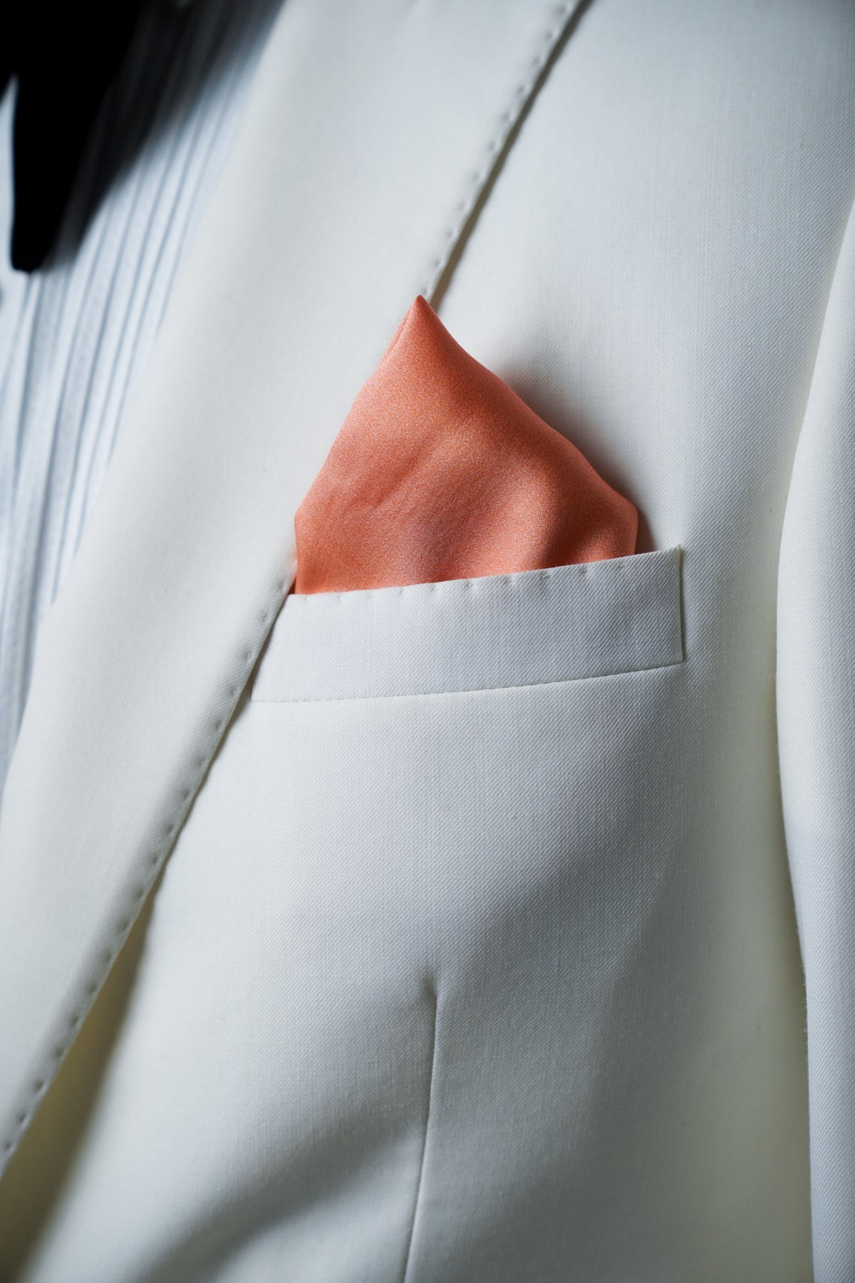Coral Blush Pocket square on white blazer